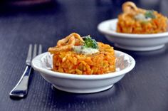 two white plates filled with food on top of a table