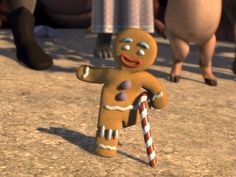 an animated ginger man holding a candy cane