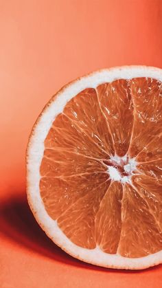 an orange cut in half sitting on top of a table