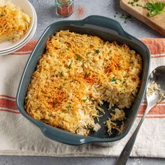 a casserole dish with cheese and parmesan toppings on the side