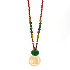 This Mystic Bohemian Elephant Necklace is a unique and colorful piece of jewelry that combines bohemian style with a touch of mysticism. The necklace features a combination of different beads including clear crystal beads, green jade beads, and colorful African beads. It also includes gold-colored hematite stone beads, gold-colored hematite Buddha beads, and gold-colored hematite stone heart beads. The necklace is highlighted by a handmade glass green color floral large bead, and it is finished Festive Spiritual Beaded Necklaces With Colorful Beads, Festive Spiritual Beaded Necklaces With Large Beads, Festive Spiritual Beaded Necklace With Colorful Beads, Festive Spiritual Large Beaded Necklaces, Festive Large Beaded Spiritual Necklaces, Festive Large Beads Spiritual Necklace, Amulet Style Wooden Beaded Necklaces For Gifts, Amulet Style Wooden Beaded Necklace For Gifts, Wooden Beads Amulet Necklace As A Gift