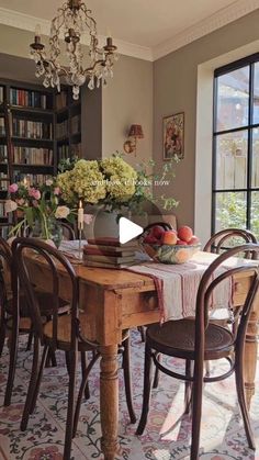 a dining room table with chairs and a chandelier