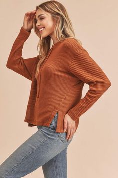 The Carole Sweater features a slouchy, oversized fit with a ribbed knit top for and lace-up detailing at the henley neckline. Style: Casual Print / Pattern: Rib Knit Fit: Oversized Neck Line: Henley Sleeve: Long Sleeve Closure: Lace-up Made In: Imported Fabric Contents: 96% Polyester 4% Spandex Non-sheer fabric Size Measurement (inch): S: 20.0 (Bust), 21.0 (Waist), 21.0 (Hips), 22.0 (Length) M: 20.5 (Bust), 21.5 (Waist), 21.5 (Hips), 22.5 (Length) L: 21.0 (Bust), 22.0 (Waist), 22.0 (Hips), 23.0 Casual Brown Henley Neckline Top, Fall Waffle Knit Henley For Loungewear, Fall Ribbed Henley For Loungewear, Casual Waffle Knit Henley For Fall, Casual Fall Henley Shirt, Casual Fall Henley, Casual Winter Waffle-knit Henley, Casual Winter Waffle Knit Henley, Fall Waffle Knit Henley With Henley Neckline