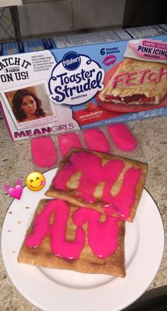 two pieces of cake on a plate with pink icing and some cereal boxes in the background