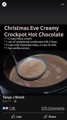 a cup of hot chocolate is being served in a crockpot with a spoon