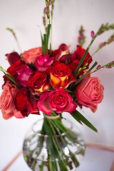 a vase filled with red and pink flowers