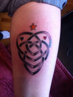 a woman's arm with a tattoo on it that has an intertwined heart