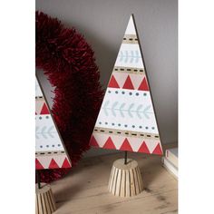 two wooden christmas trees sitting on top of a table