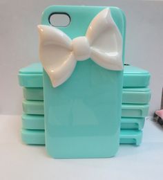 there is a blue case with a white bow on it and four other cases in the background