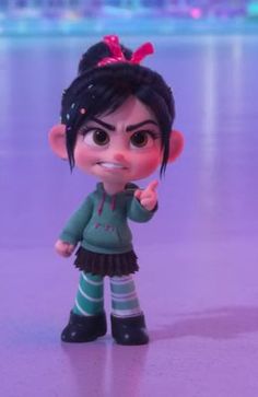 a toy doll with black hair and green shirt standing on ice rink next to water