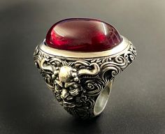 RING PROFILE: 🔱 Indulge in the allure of the 'Devil's Blood Ring,' a captivating piece that embodies the mystique of dark elegance. Crafted with precision and imbued with a touch of the infernal, this ring is a mesmerizing fusion of sophistication and edge. The deep, crimson hues evoke a sense of forbidden passion, while the intricate design channels the essence of the occult. Elevate your style with this unique accessory that beckons the daring and those drawn to the darker realms. The Devil's Blood Rings, Blood Ring, Vampire Ring, Blood Ruby, Fantasy Demon, Dark Elegance, Exotic Jewelry, Tarnish Remover, Large Ring