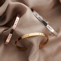 two bracelets that say your own and be brave on the same piece of cloth