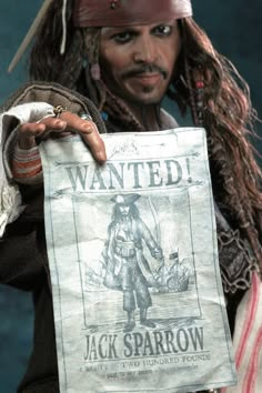 a close up of a person holding a paper with a pirate on it's face