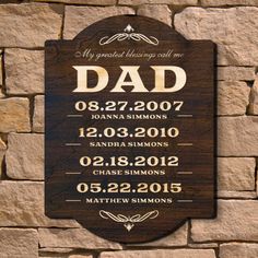 a wooden sign on the side of a stone wall that says, my greatest blessing will be dad