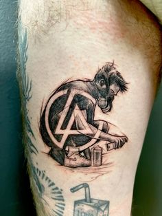 a tattoo on the leg of a man with a horse and an anarchy symbol around it