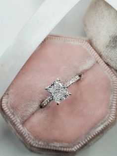 an engagement ring in a pink velvet case