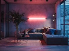 a living room filled with furniture and a pink light coming from the window behind it