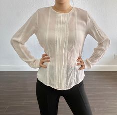 "Vintage white silk long sleeve blouse. Pleating and lace detail down the front with button closure in the back. Great vintage condition! 15\" shoulder 35\" chest 21\" length We don't process returns or exchanges. Please feel free to ask any questions before purchasing. I try to note any noticeable flaws if there is any. Items may come with minor flaws due to pre-loved wear. I love vintage for its uniqueness and I hope you can appreciate this garment and its character." Elegant Fitted Long Sleeve Top For Work, Elegant Long Sleeve Blouse With Sheer Sleeves, Elegant Long Sleeve Top With Sheer Sleeves For Fall, Sheer Long Sleeve Tops For Office, Long Sleeve Sheer Tops For Office, Office Tops With Sheer Long Sleeves, Elegant Long Sleeve Tops With Lace Cuffs, Elegant Long Sleeve Top With Lace Sleeves, Long Sleeve Tops With Sheer Sleeves For Office