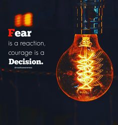 a light bulb with a quote on it saying fear is a reaction, courage is a decision