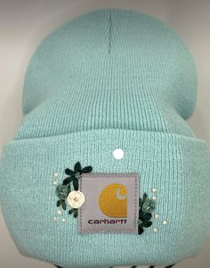 a beanie hat with an embroidered patch on it