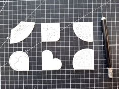 four pieces of paper cut out to look like hearts