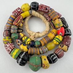 A strand of mixed Venetian beads traded to Africa in the late 1800's to early 1900's. Overall good condition with small to a few. 45 beads 25" of beads 63cm 30.5" with raffia 7 to 21mm diameter 2mm hole Antique Hand-strung Oval Beads, Hand-strung Antique Oval Beads, Antique Round Spacer Beads, Artisan Hand-strung Oval Beads, Hand-strung Artisan Oval Beads, Antique Multicolor Handmade Beads, Antique Handmade Multicolor Beads, Antique Style Handmade Multicolor Beads, Traditional Beaded Bracelet With Large Oval Beads