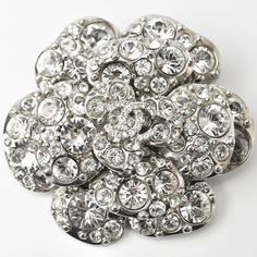 Used Chanel Brooch Pin Camellia Motif Coco Mark Rhinestone Silver (Sku: Gzl12oq8) === General === Brand : Chanel Line : Camellia Model : 2405c15-Ch Country Of Origin : France === Design === Type : Pin Brooch Gender : Women Material : Rhinestone Color : Silver Stone : Rhinestone === Size === Size (Hxwxd) : 5.5cm X 5.6cm / 2.16'' X 2.2'' === Included Items === Accessories : Box Accessories Notice : Before Purchasing, Please Refer To The Images Of The Accessories Included With The Item. === Conditi Luxury Silver Rhinestone Brooches, Luxury Silver Brooches With Rhinestones, Glamorous Formal Brooches With Rhinestones, Luxury Rhinestone Brooches For Formal Occasions, Luxury Rhinestone Brooch For Formal Occasions, Glamorous Crystal Brooches For Formal Occasions, Glamorous Silver Bling Brooch, Formal Crystal Brooches With Rhinestones, Elegant Silver Sparkling Brooches