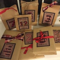 brown paper bags with red ribbon and numbers on them