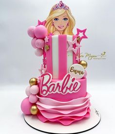 a barbie birthday cake with pink and gold decorations