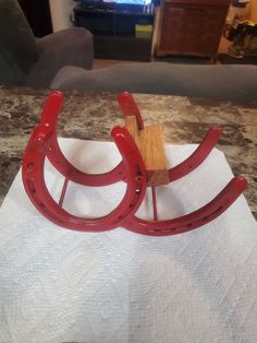 a pair of red wooden sleighs sitting on top of a white towel