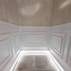 an empty room with white walls and tile flooring in the center is lit by recessed lighting