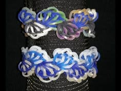 two bracelets made out of plastic beads on a mannequin neck piece, one in blue and the other in white