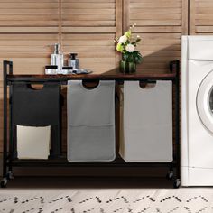 a washer and dryer sitting next to each other in front of a wooden wall