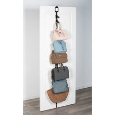 an over the door purse holder with five bags hanging from it's hooks, in front of a white wall