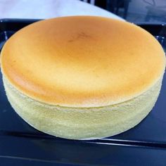 a round cake sitting on top of a black tray