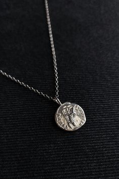 This necklace is composed of sterling silver 925 chain and ancient roman spinner coin pendant, a very durable and fashionable piece that compliments any outfit. Perfect gift for him! ✺Chain width: 2 mm ✺Pendant length: 0.8 inch / 2 cm Available in various lengths. Measure your desired length and order accordingly.  How to find the perfect length for you: ❉ Use a soft measuring tape or a string to mark where you would like the necklace to hang ❉ Then measure the string's length with a ruller If y Silver Necklace Men, Boy Necklace, Mens Pendant Necklace, Mens Necklace Pendant Vintage, Ancient Style Coin Pendant Necklace For Gift, Ancient Style Coin Pendant Necklace, Ancient Silver Pendant Necklace, Mythological Silver Jewelry With Coin Pendant, Roman Coin Necklace