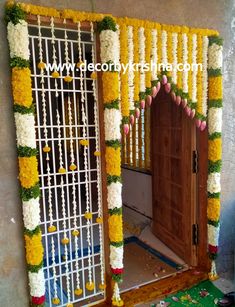 an entrance decorated with flowers and garlands for a wedding ceremony at the same time