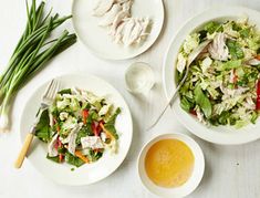 two white plates filled with salad and dressing