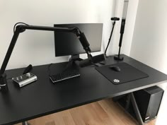 a desk with a keyboard, mouse and monitor on it