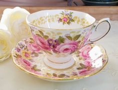 a tea cup and saucer sitting on a table