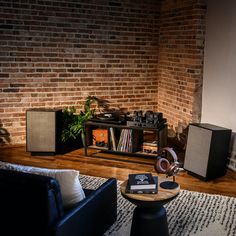 a living room filled with furniture and a brick wall