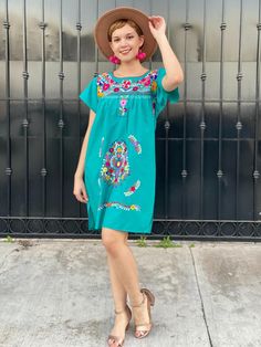 "Mexican embroidered dress women, hand embroidery tunic, cotton short sleeve summer dress, boho hippie sundress, tropical vacation, frida A very bright and fun traditional Mexican dress, short sleeve, teal and multicolor hand embroidered flowers. Great piece to wear in spring, summer, mexican festivities or if you go to a Mexico destination vacay. Loose fit Made of Cotton Fits size SMALL (maybe Medium, check measurements) Measurements taken flat: - Armpit to armpit 21 1/2\" - Bottom hem width 23 Embroidered Short Sleeve Dresses For Summer, Summer Embroidered Boho Hippie Dress, Embroidered Boho Hippie Dress For Summer, Summer Embroidered Mini Dress, Embroidered Summer Sundress For Vacation, Summer Sundress With Floral Embroidery For Vacation, Bohemian Sundress With Floral Embroidery, Embroidered Short Sleeve Boho Summer Dress, Beach Embroidered Dress With Embroidered Neckline