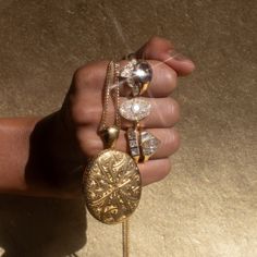 a person holding some kind of jewelry in their hand and wearing it on a stick