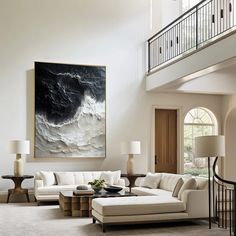 a living room filled with furniture and a painting on the wall above it's fireplace