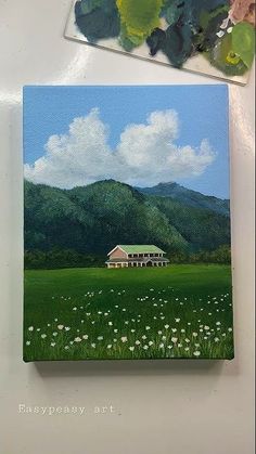 a painting of a house in the middle of a green field with mountains behind it