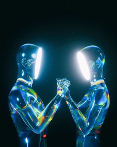 two glass figures holding hands in front of a black background with light coming through them