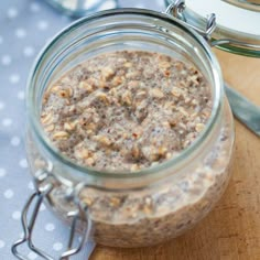 a glass jar filled with oatmeal sitting on top of a wooden cutting board