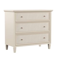 a white dresser with three drawers on it