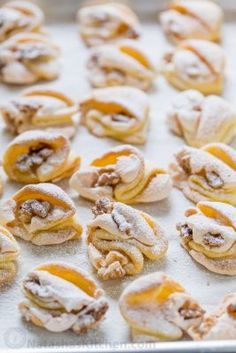 powdered sugar covered pastries on a baking sheet