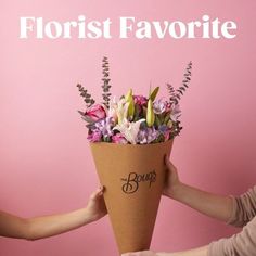 two hands holding a bouquet of flowers with the words florist favorite